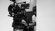 A filmmaker behind a film camera.